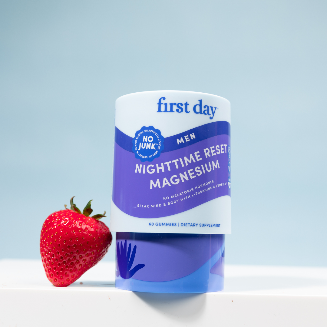 Supplement container labeled 'first day' with a strawberry on a light blue background