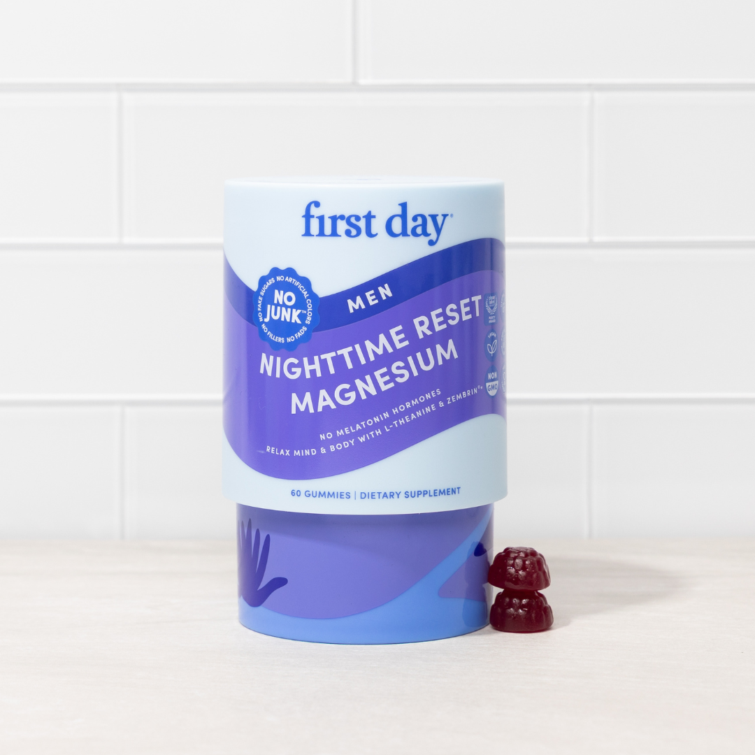 Blue container of 'first day' nighttime reset magnesium supplement with gummies on a white background