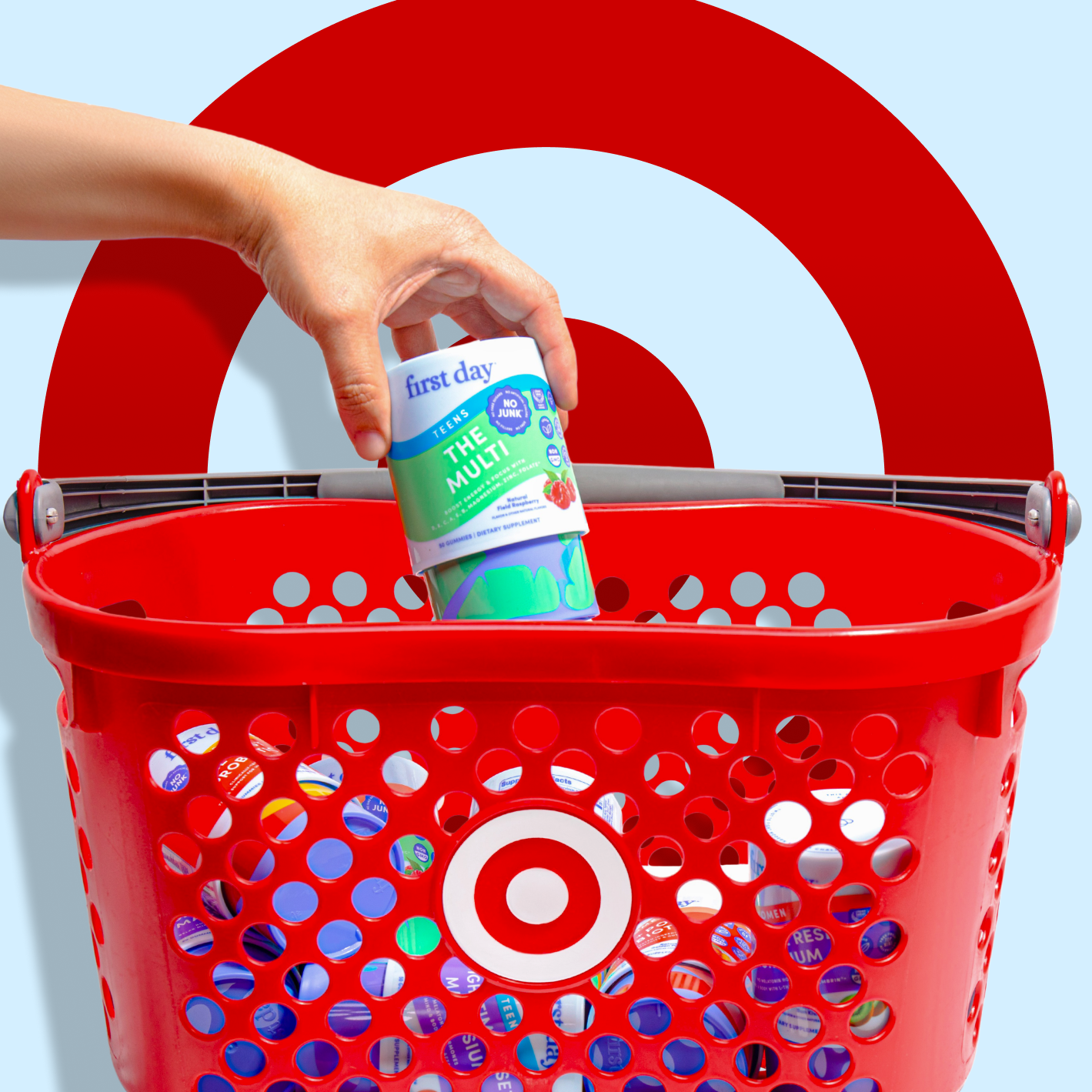 Red Target shopping basket with a hand placing a bottle inside, against a blue background.