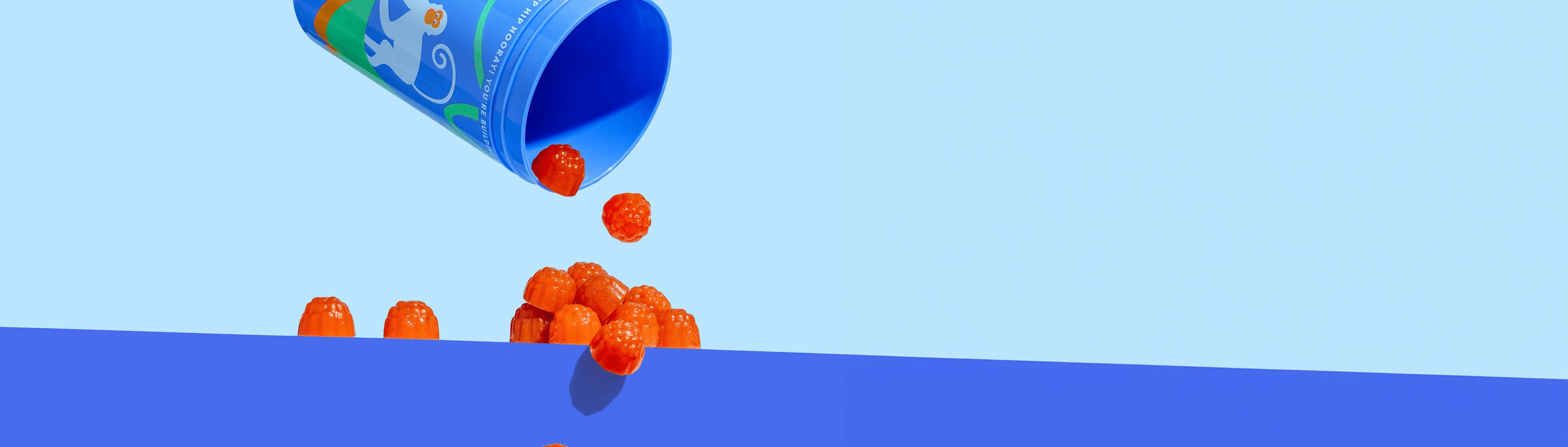 Vitamins pouring out of cup.