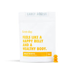 A white pouch labeled Kids' Belly-Biotic - Free Gift For Life with yellow text promotes probiotic gummies for kids. Two orange gummies are beside the pack, which says 