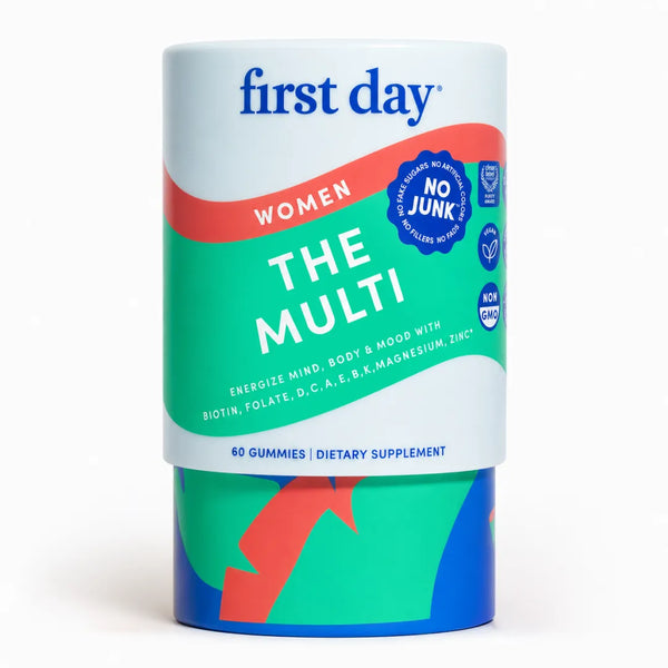 A cylindrical container of First Day Women The Multi dietary supplement gummies, featuring a white, green, and red label with blue branding, set against a plain white background.