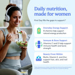 Promotional graphic with a smiling woman wearing white headphones and eating from a glass bowl, alongside large blue text reading 'Daily nutrition, made for women' and three benefit callouts for women's health and beauty.